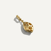 Gold pendant with a textured design on a white background