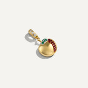 Gold pendant with gemstones on a white background