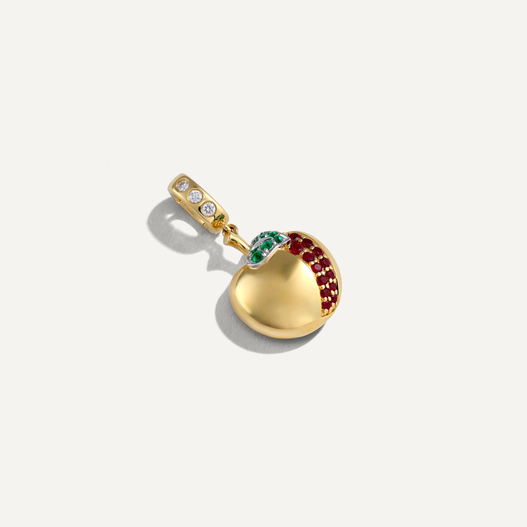 Gold pendant with gemstones on a white background