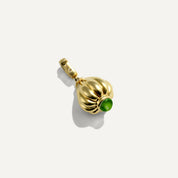 Gold pendant with a green gemstone on a white background