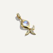 Gold pendant with a central gemstone on a white background