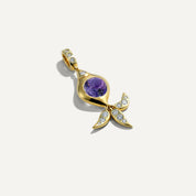 Gold pendant with purple gemstone and diamond accents on a white background