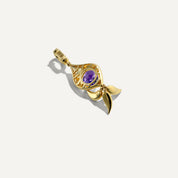 Gold pendant with a purple gemstone on a white background