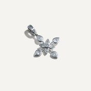 Silver floral pendant with teardrop-shaped gemstones on a light gray background
