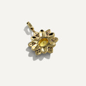 Gold pendant with gemstones on a white background