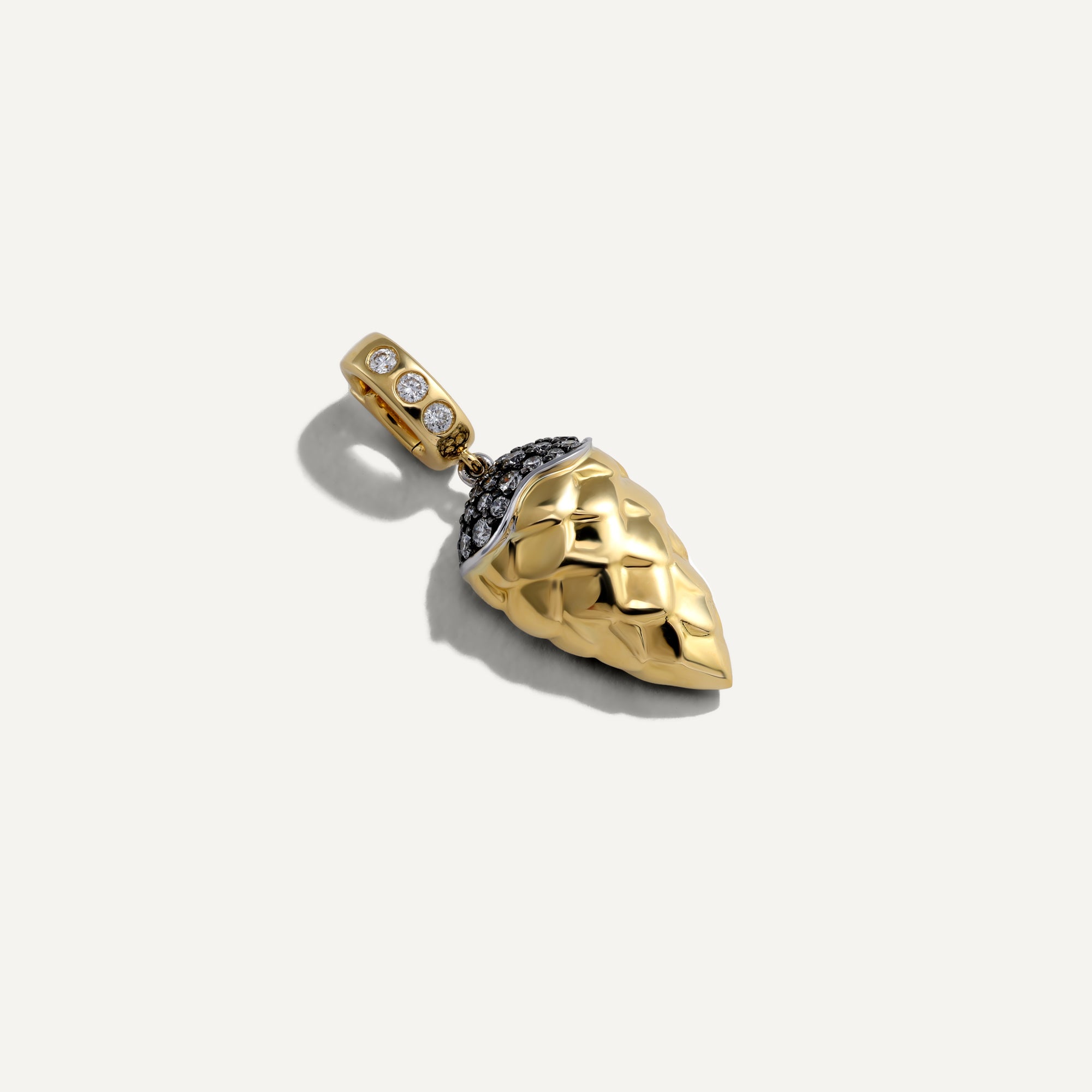 Gold pendant with gemstones on a white background