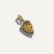 Gold pendant with intricate design on a white background