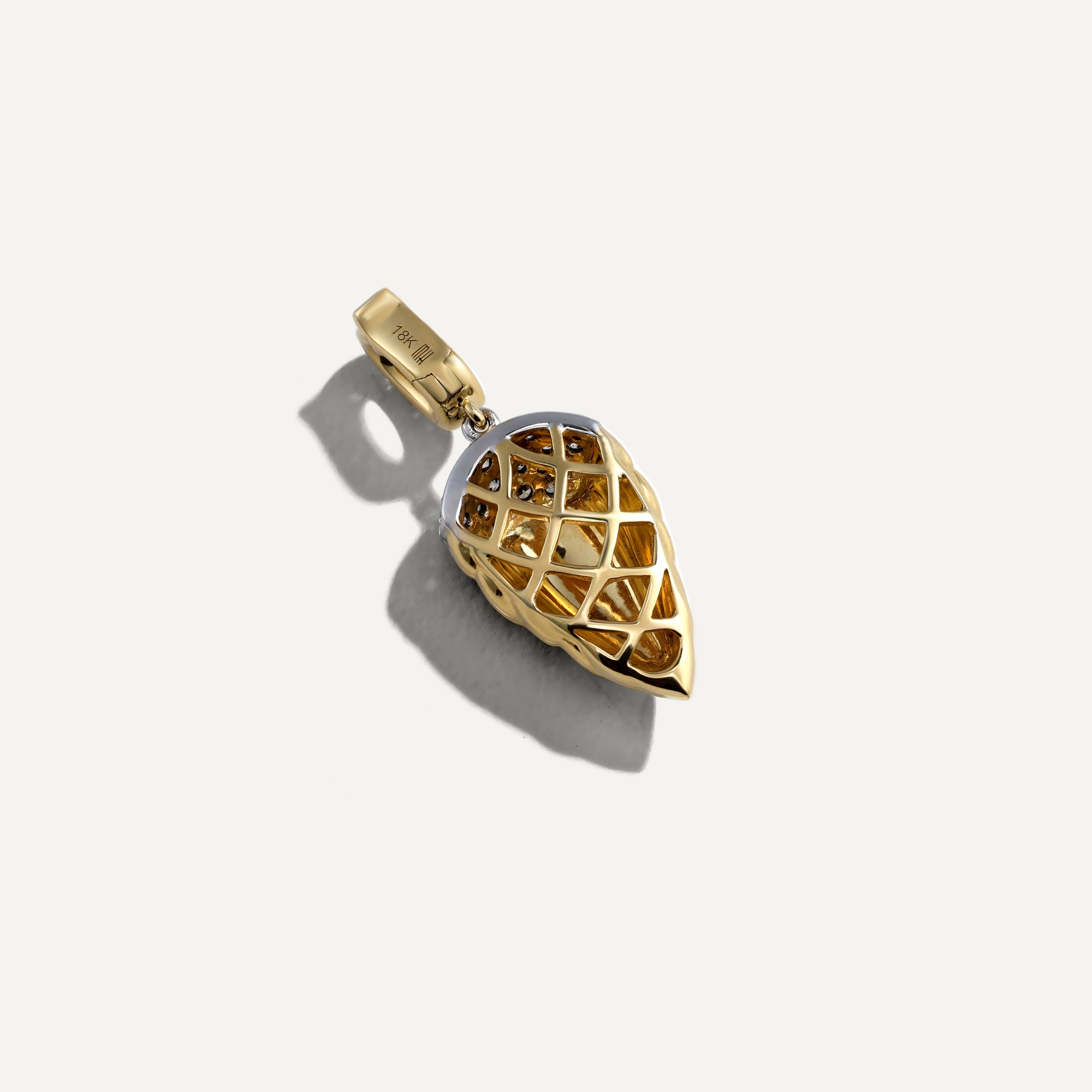 Gold pendant with intricate design on a white background