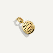 Gold charm with a textured design on a white background